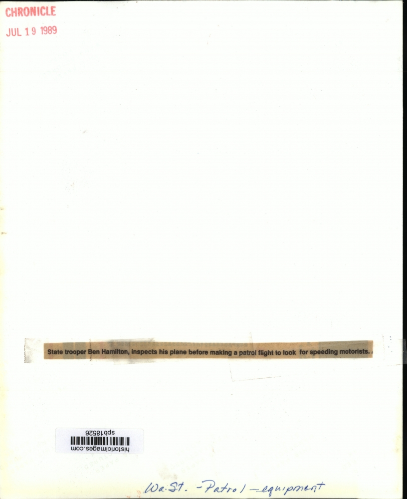 1989 State Trooper Ben Hamilton inspects his Plane in Washington